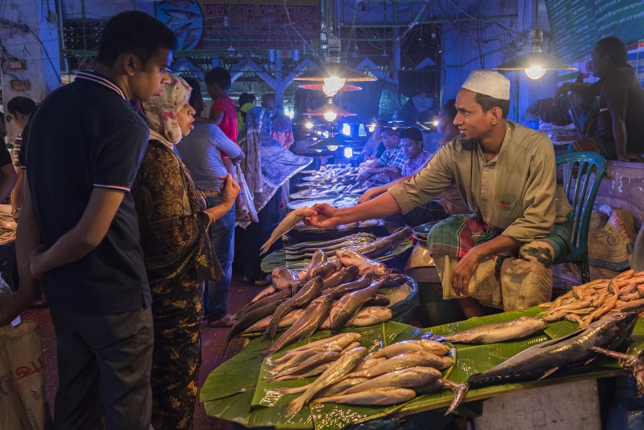 Couple bargaining with a Fish Seller