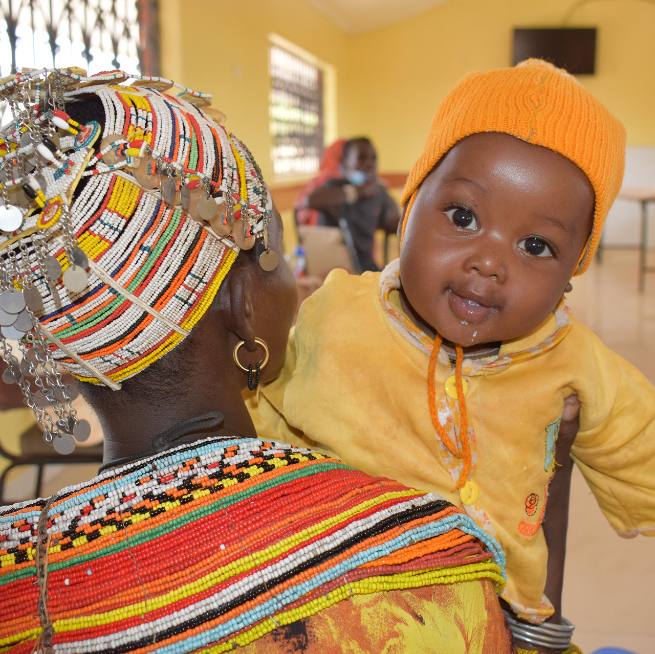A Community Health Volunteer in Marsabit County in Northern Kenya holds her seven month old baby.