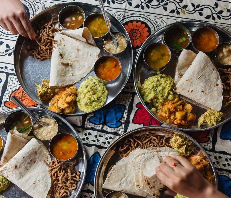 Photo showing hands and plates of food