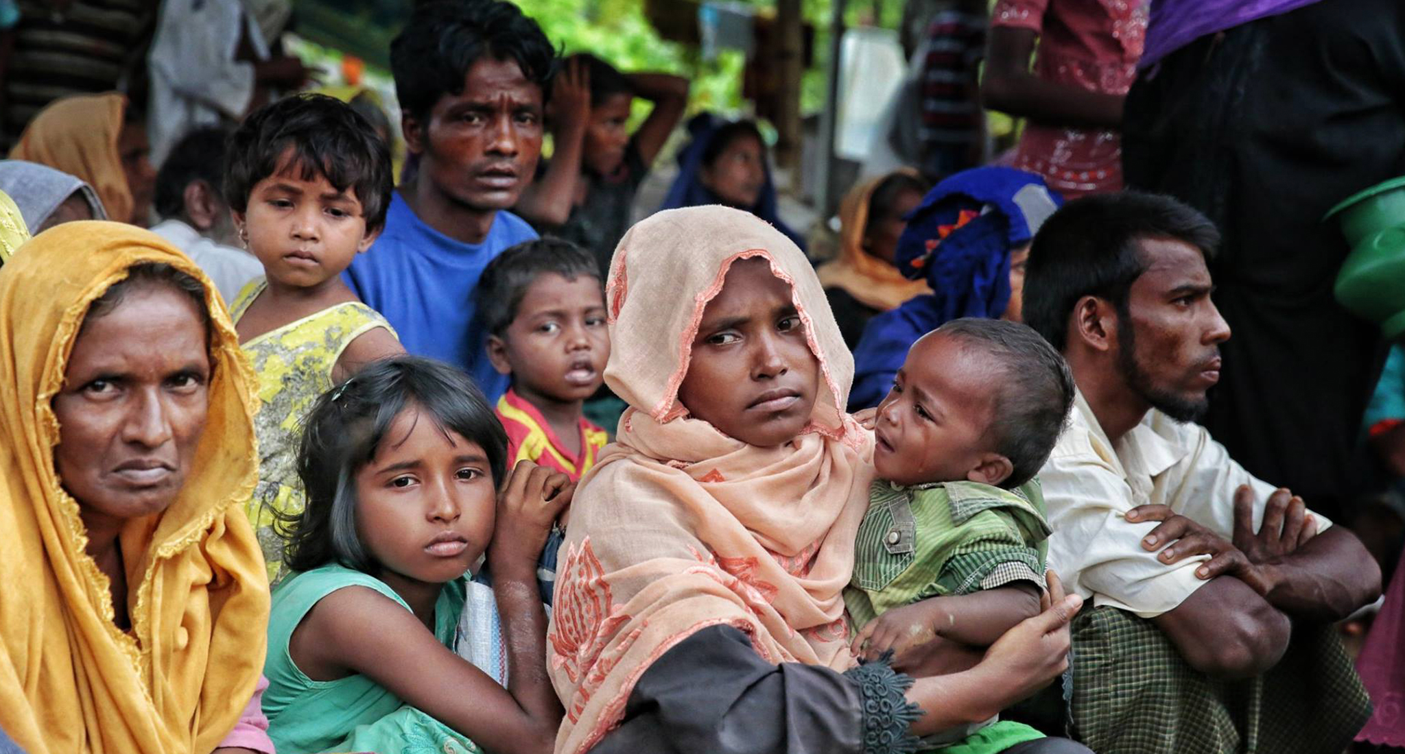 Photo of a group of Rohingya refugees sitting outside, who are part of a half a million Rohingya refugees flooded across the border to Bangladesh to escape violence in Burma’s Rakhine State, including the elderly, pregnant women and children.
