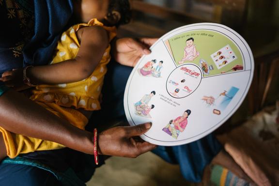 Photo of a woman holding a nutrition instruction wheel