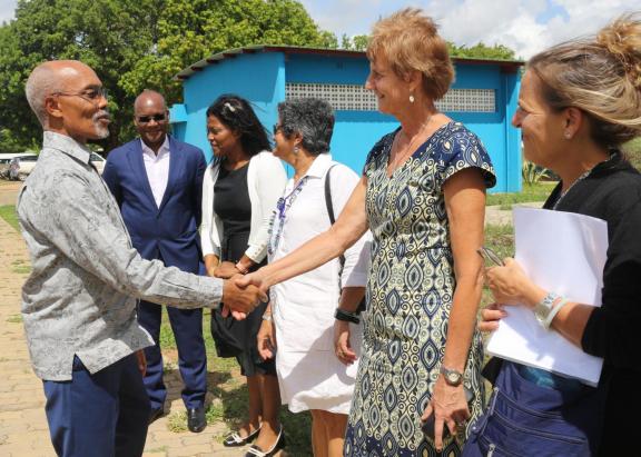 Photo of people standing together and shaking hands at the launch of the new office in Mozambique.