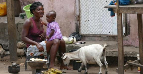 Woman with her child and goat at the market