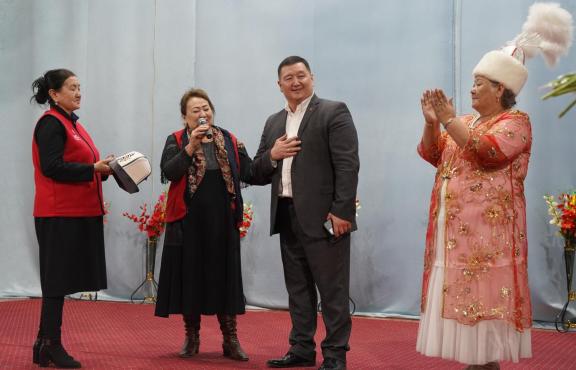 Guests thank concert organizers on stage in Kadamzhai, Batken Oblast
