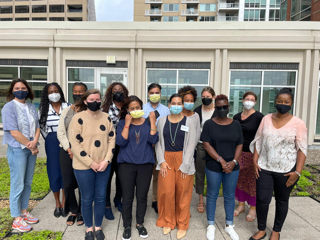 Training participants and facilitators pose for a picture while wearing their masks.