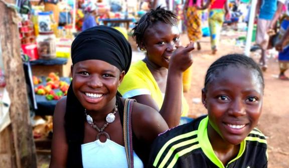 Young girls in a local market, smiling for the camera