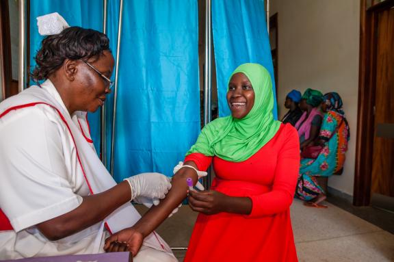 A health worker at Mulago antenatal clinic collecting blood sample from a pregnant woman for haemoglobin estimation during one of the days of the routine ANC visits