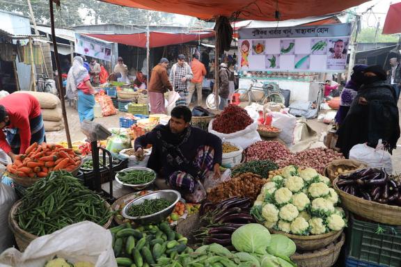 A food vendor is offering diverse nutritious vegetables to rural household consumers at a market center in Faridpur, Bangladesh.