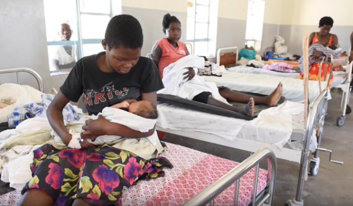Still image from a video of a mother breastfeeding in a maternity ward