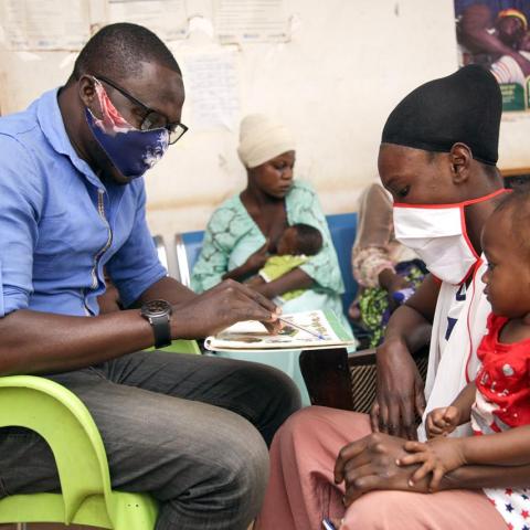 community health worker provides counseling to a mother and infant