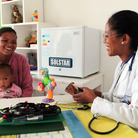 Photo of a woman with infant meeting a doctor