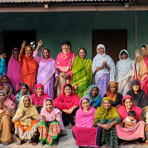 Group photo of women outside, in front of a building.