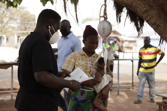 Ghana GMP Health Worker counseling a young mother