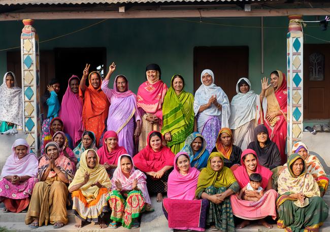 Group photo of women outside, in front of a building.