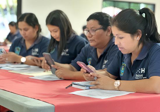 Training users on their phones for the Digital Nutrition Activities Registration Tool (REDI-AN) in a classroom, Gestor de Salud Lepaera, Lempira.