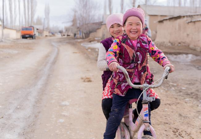 Children in Batken oblast riding a bicycle