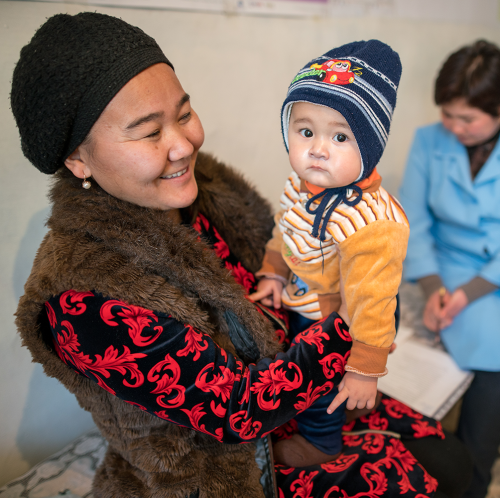 Woman holding her toddler at the clinic