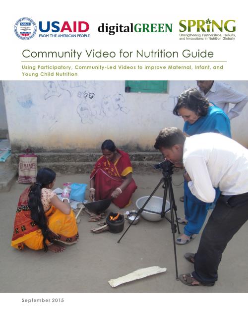Local women cooking food outside, being filmed by a community videographer. 