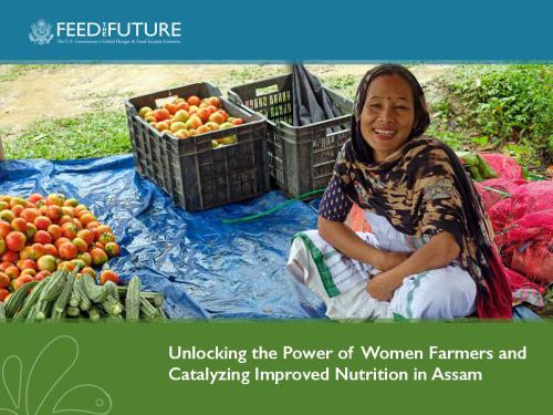 Feed the Future: The U.S. Government’s Global Hunger and Food Security Initiative logo   Photo: a woman smiling at the camera. Fresh tomatoes in a storage container are in the background.   Title: Unlocking the Power of Women Farmers and Catalyzing Improved Nutrition in Assam. 